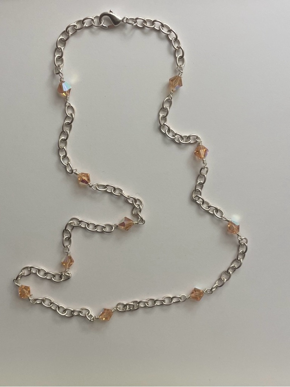 Silver chain necklace with orange beads
